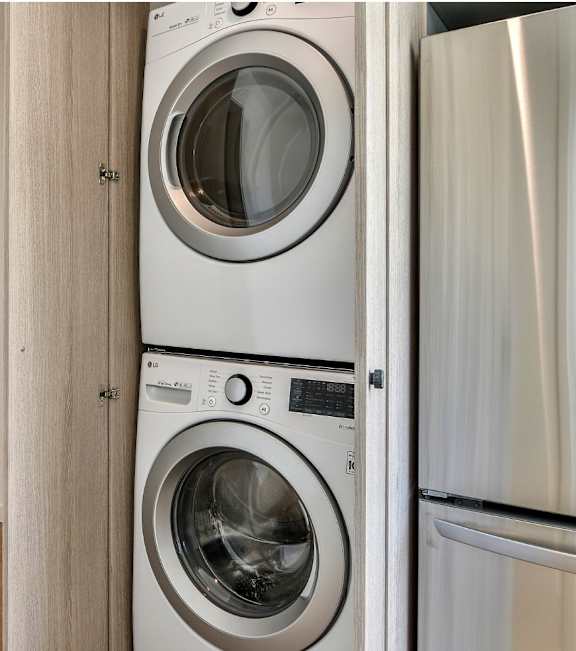 a white washer and dryer in a small laundry room at 8535 Colgate-Fully Furnished Apartments, Los Angeles, CA, 90048