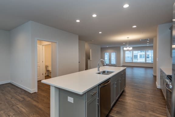 a kitchen with an island and a sink in a new home