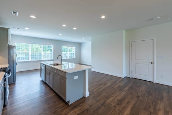 an empty kitchen with a large island in the middle