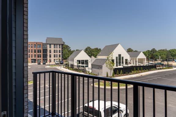 A parking lot with cars and a building in the background.