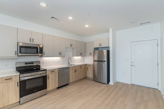 A kitchen with wooden cabinets and stainless steel appliances.