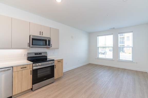 A kitchen with wooden cabinets and stainless steel appliances.