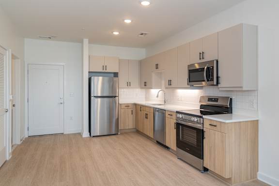 A kitchen with wooden cabinets and stainless steel appliances.