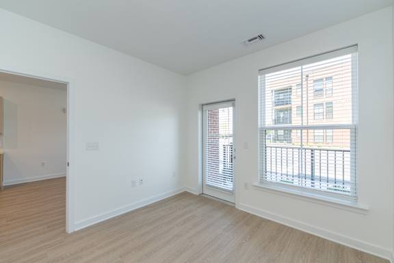 A room with a window and a door.