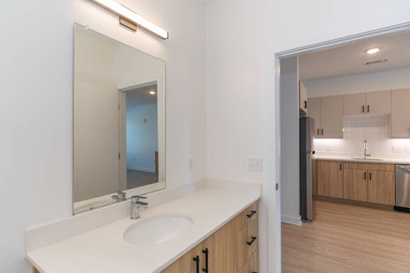 A bathroom with a sink and mirror.