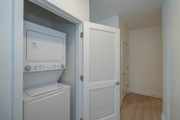 Stackable washer/dryer conveniently located in hallway