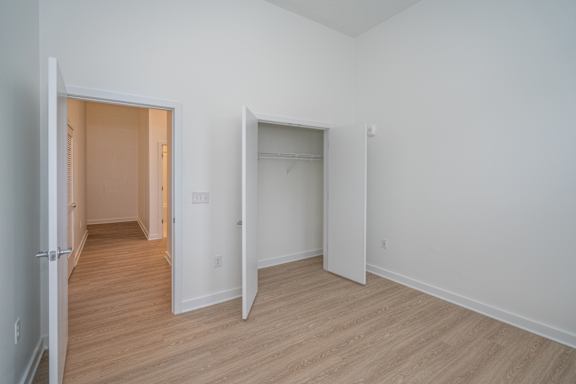 Spacious second bedroom with large closet and tall ceilings