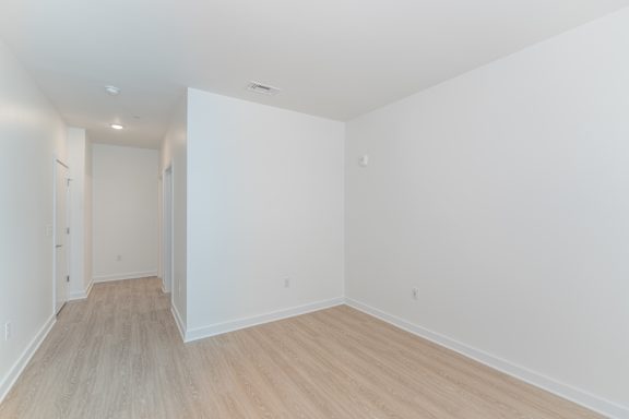 A room with white walls and wooden flooring.
