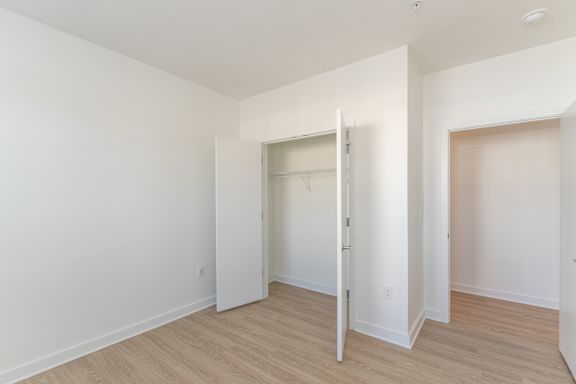 A room with a white door and a white wall.