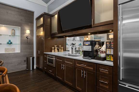 A modern kitchen with dark wood cabinets and stainless steel appliances. at Merion at Cross Keys Apartments, Apartments, Williamstown, NJ