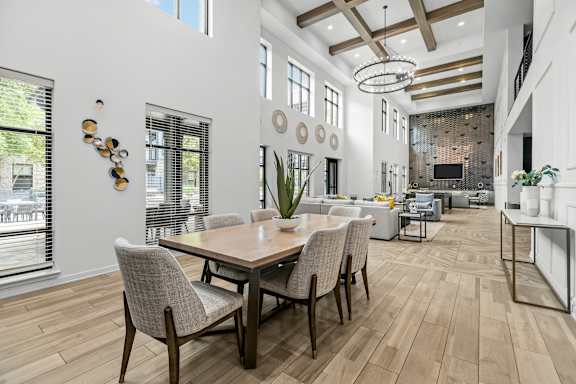 A dining room with a wooden table and chairs.