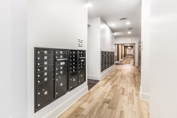 a long hallway with a locker room with wooden floors