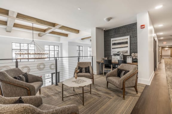 a living room with chairs and a table