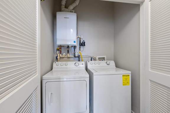 A white washing machine and dryer in a small laundry room.
