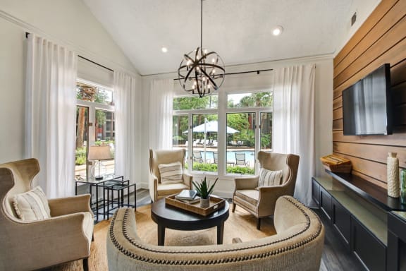 a living room with a table and chairs and a large window at Timberwalk at Mandarin Apartment Homes, Florida, 32257