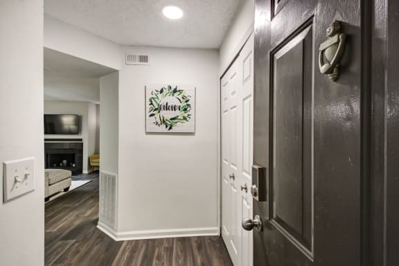 a hallway with a door and a living room with a fireplace at Timberwalk at Mandarin Apartment Homes, Florida, 32257