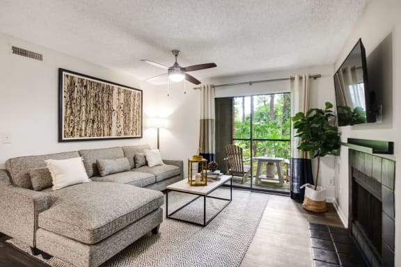 a living room with a couch and a chair and a ceiling fan at Timberwalk at Mandarin Apartment Homes, Florida, 32257