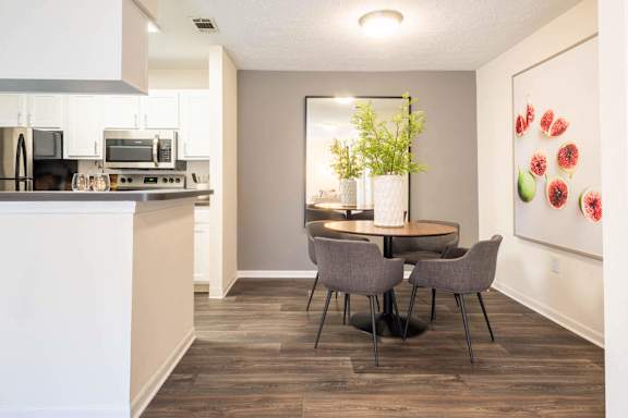 a kitchen and dining room with a table and chairs