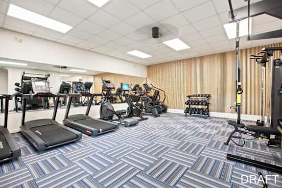 A gym with treadmills, exercise bikes, and other equipment.