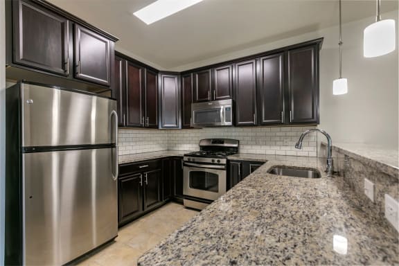 a kitchen with stainless steel appliances and granite counter tops at The Collings at the Lumberyard, Collingswood, NJ, 08108