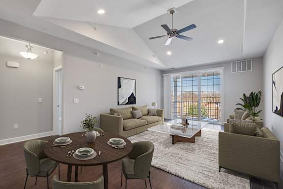 A modern dining room with a round table set for six.