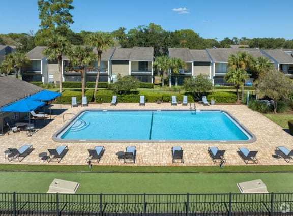 an aerial view of a swimming pool in front of an apartment building at The Fountains at Deerwood Apartments ,Jacksonville
