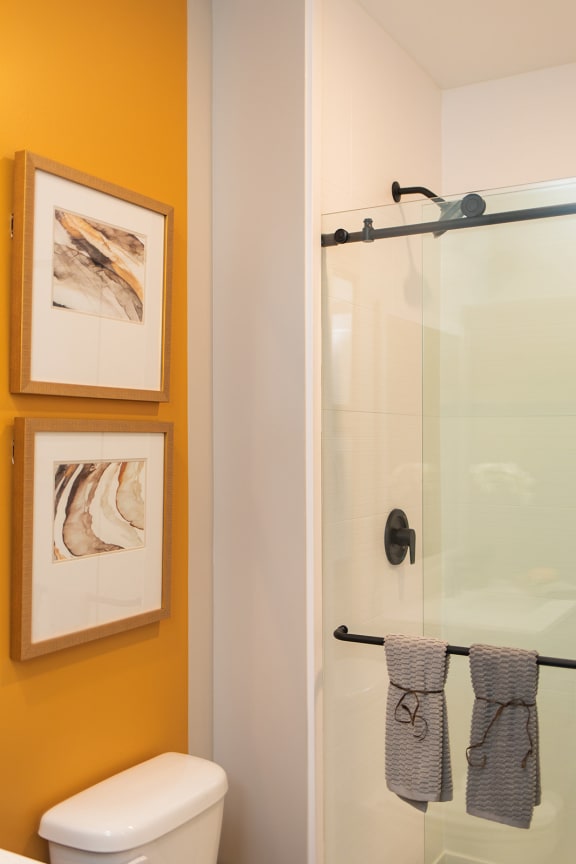 a bathroom with a toilet and a glass shower at The Yards at Malvern, Malvern, PA