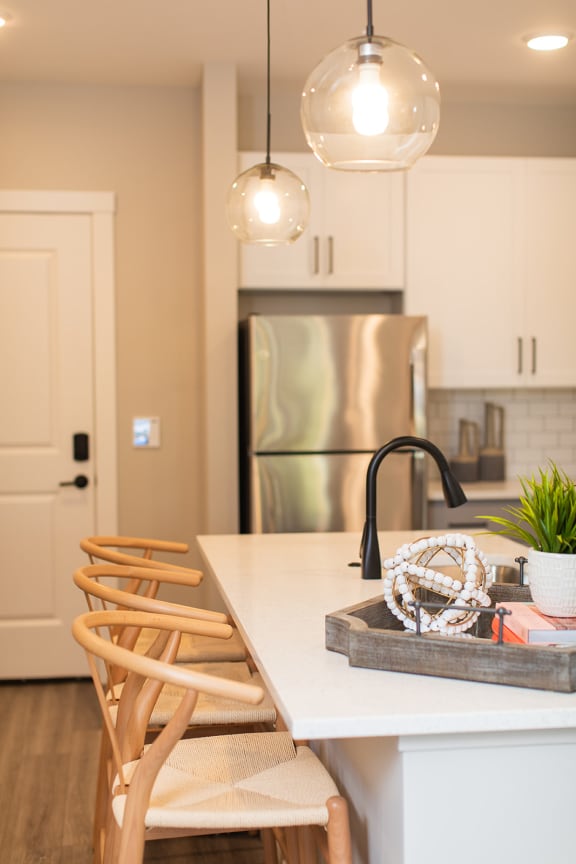 a kitchen with a white counter top and a stainless steel refrigerator at The Yards at Malvern, Malvern, PA