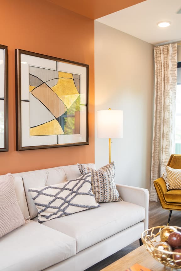 a living room with a white couch and two paintings on the wall at The Yards at Malvern, Malvern, PA