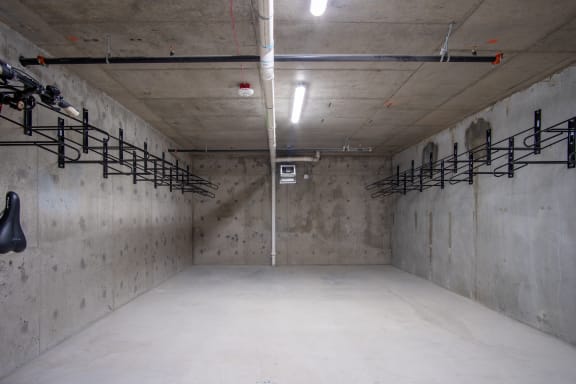 a large empty parking garage with concrete walls and a white pipe running up the side of the