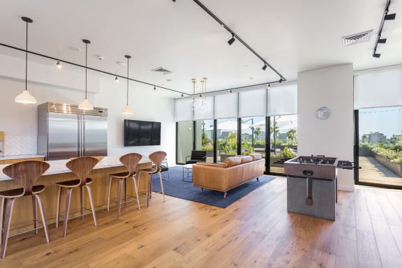An open living room with a kitchen and dining area at Mariposa on 3rd, Los Angeles, CA 90004