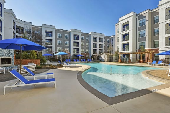 furnished pool area and aparmtent building on sunny day  at The Brookhaven Collection, Atlanta