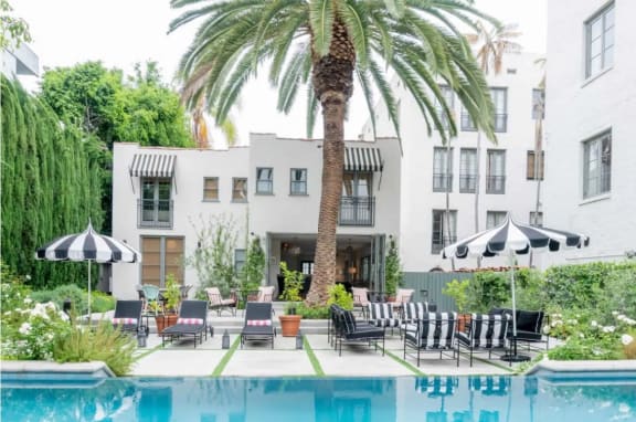 Villa Carlotta in Los Angeles, CA saltwater pool with lounge chairs and umbrellas