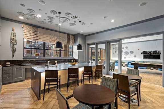 A modern kitchen with a dining table and chairs.