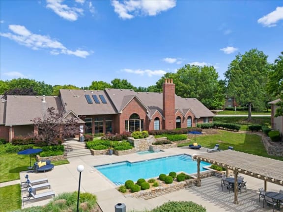 a backyard with a pool and a house at Highland Park Apartment Homes, Overland Park