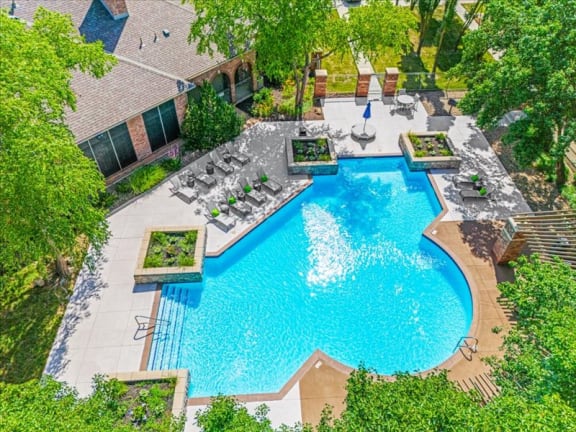 an aerial view of a resort style pool with chairs and trees at Crescent Apartment Homes, Lenexa, 66219