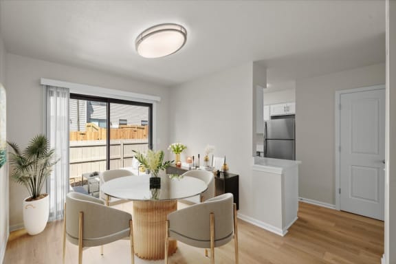 a living room and dining room with a table and chairs