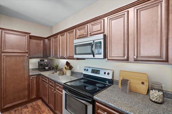 a kitchen with a stove and a microwave at Stonepost Ranch, Kansas, 66221