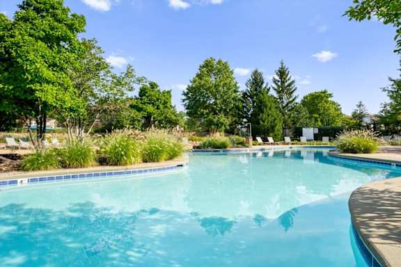 Large Swimming pool surrounded by greenery at Stonepost Ranch Apartments, Overland Park