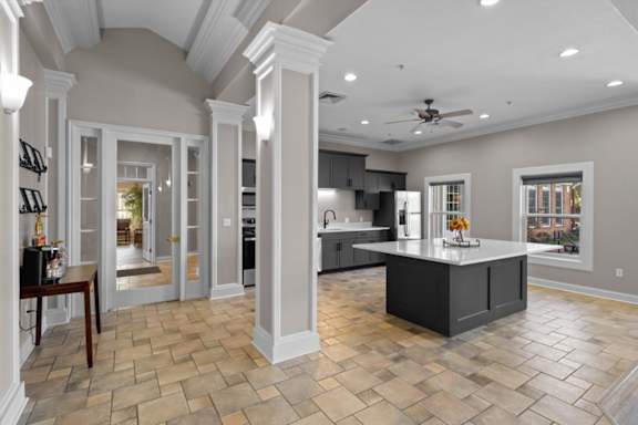 A spacious kitchen with a central island and a ceiling fan. at Somerset Oaks Apartment Homes, Olathe, KS, 66062