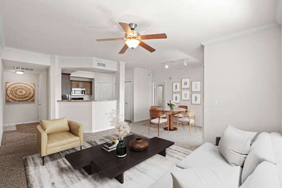 A living room with a ceiling fan and crown molding.