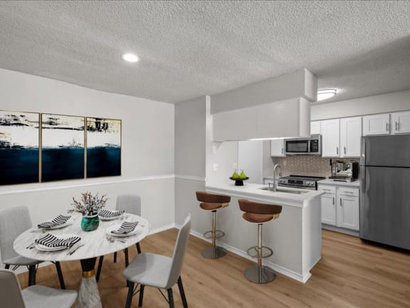 a kitchen and dining room with a table and chairs
