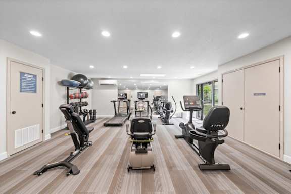 Gym with modern equipments at Cloverset Active Adult Apartments, Kansas City, MO