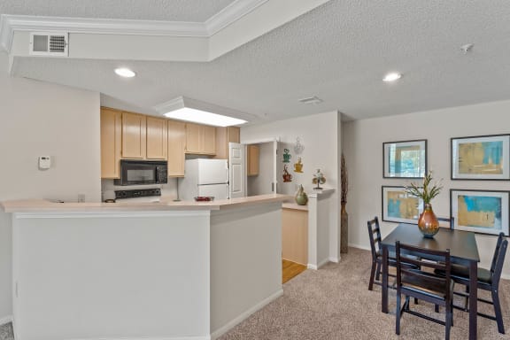 a kitchen and dining area in a 555 waverly unit at Claremont, Overland Park