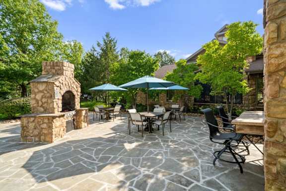 Patio with stone fireplace at Stonepost Ranch Apartments, Overland Park, Kansas