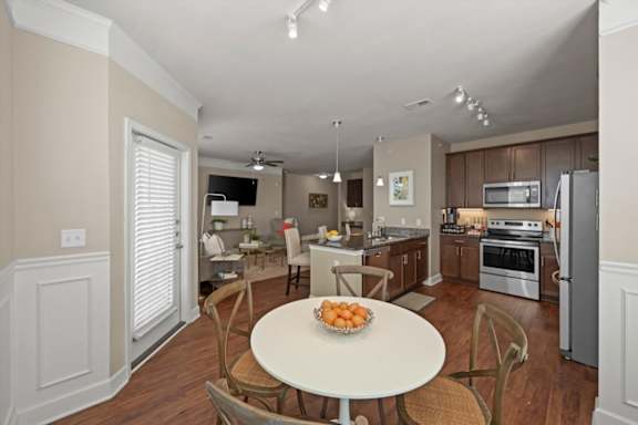 A kitchen with a table and chairs in the middle of the room.