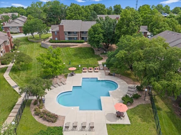 an aerial view of a swimming pool in the backyard of a house at Highland Park Apartment Homes, Kansas, 66214