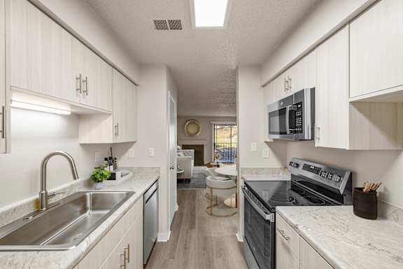 Modern Kitchen with cabinets and appliances at Cloverset Active Adult Apartments, Kansas City, MO, 64114
