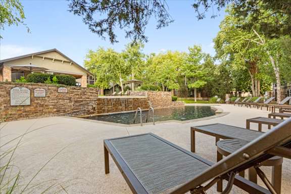 Pool Side Relaxing Area With Lounge Area at Deer Creek Apartment Homes, Overland Park, Kansas