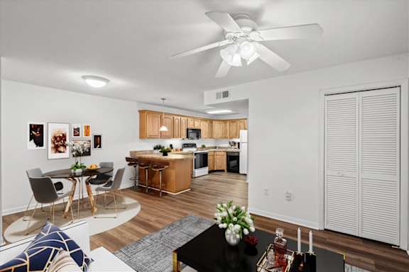 A modern kitchen with a dining table and chairs. at Malvern Hill Apartment Homes, 66103, Kansas